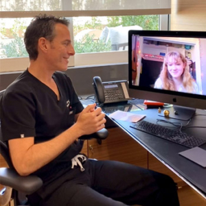 Neal in conversation with Bunion Surgery patient over telehealth video call
