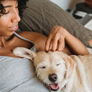 Woman before surgery relaxing with her dog